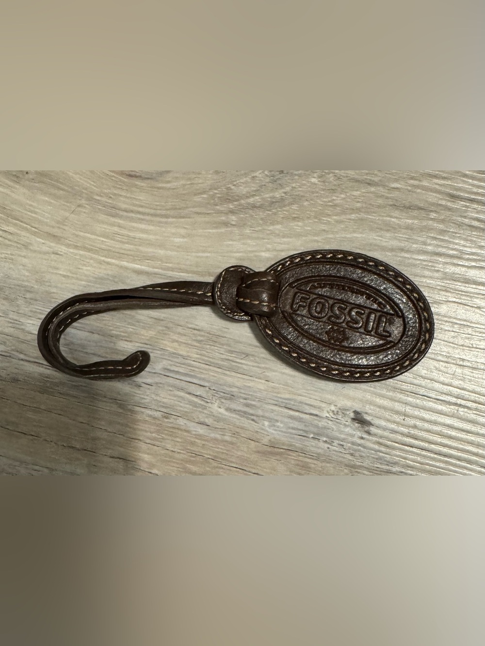 Fossil. A vintage leather bag charm from Fossil featuring the recognizable embos